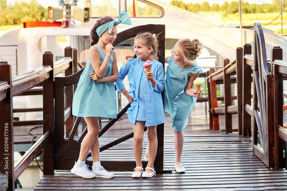 Group 3 fashion lady kids in elegant striped dresses in marine style.Little  girls cool,summer clothes outdoors.Designer children's  collection.Friendship,smile,resting together,standing on bridge. Stock  Photo | Adobe Stock