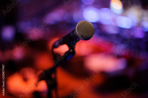 Microphone with metal body in holder on the blurred background