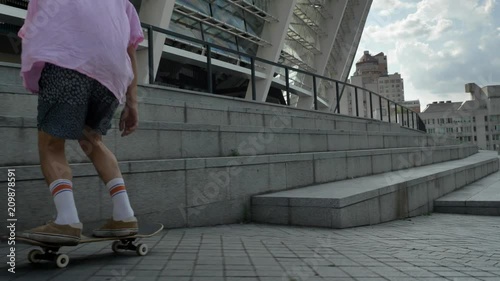 Silhouette of young man hipster is riding skateboard in daytime in summer, urban concept, sport concept photo