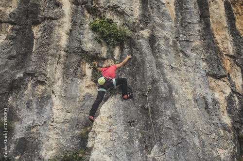 A Woman Climbing a Rock