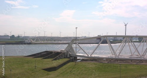 description Two doors of the opened Maeslantkering or Maeslant Storm Surge Barrier, part of the Europoort Barrier of the Dutch Delta Plan, well protected in drydock ashore. photo