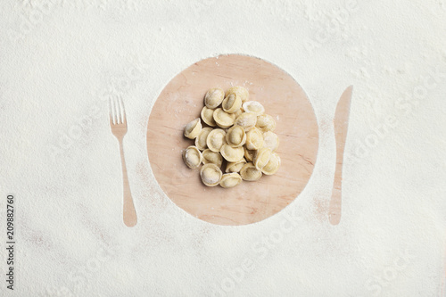 Silhouette of appliances on table covered with flour photo