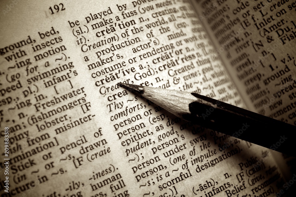 Black pencil point on creative word on old dictionary Black pencil point on creative word on old dictionary