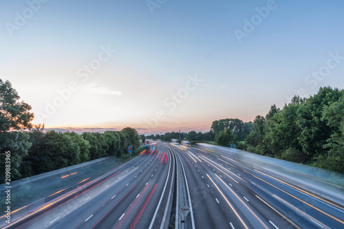 Sunset view heavy traffic moving at speed on UK motorway in England photo