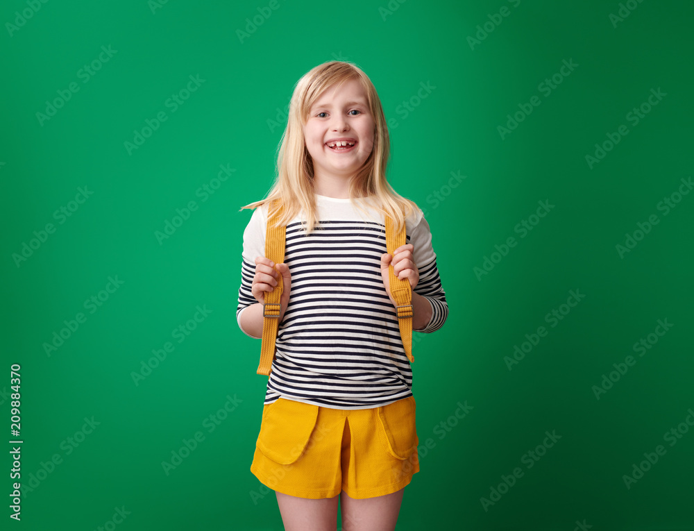Portrait of happy pupil with backpack isolated on green Portrait of happy pupil with backpack isolated on green