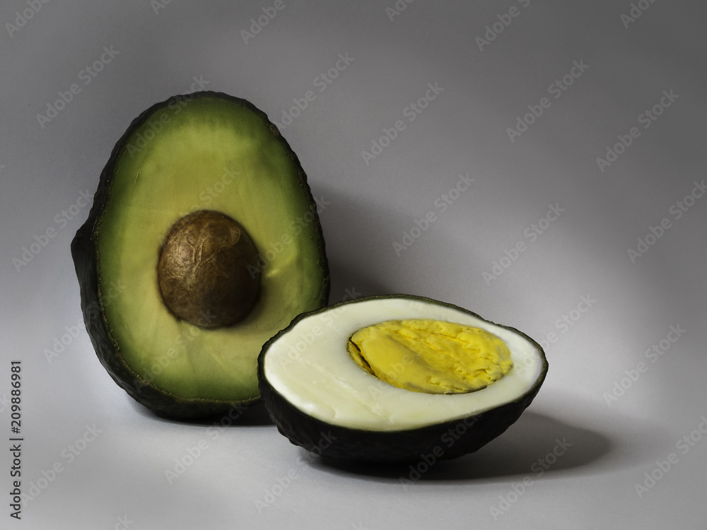 Creative still life of an egg inside an avocado