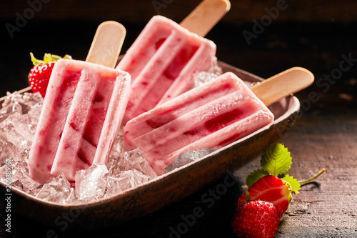 Tasty ice lolly with strawberries
