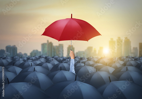 businessman with red umbrella among others, unique different concept