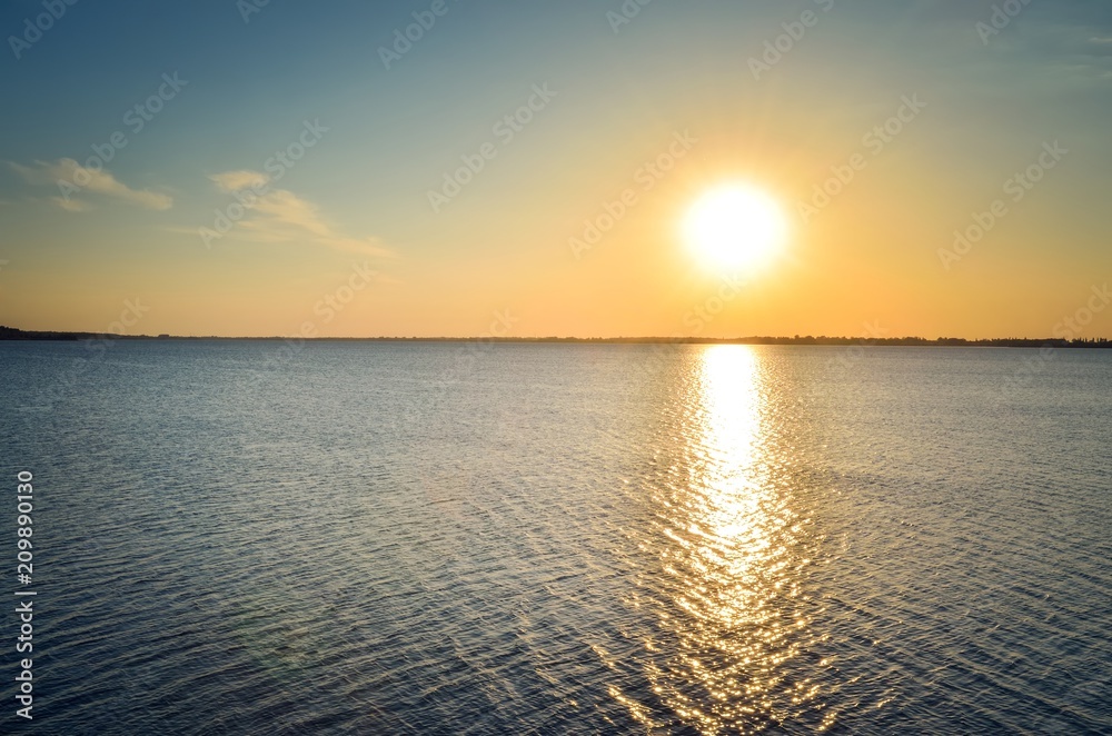 Sunny summer landscape. Beautiful sunset on the lake. Sunny summer landscape. Beautiful sunset on the lake.