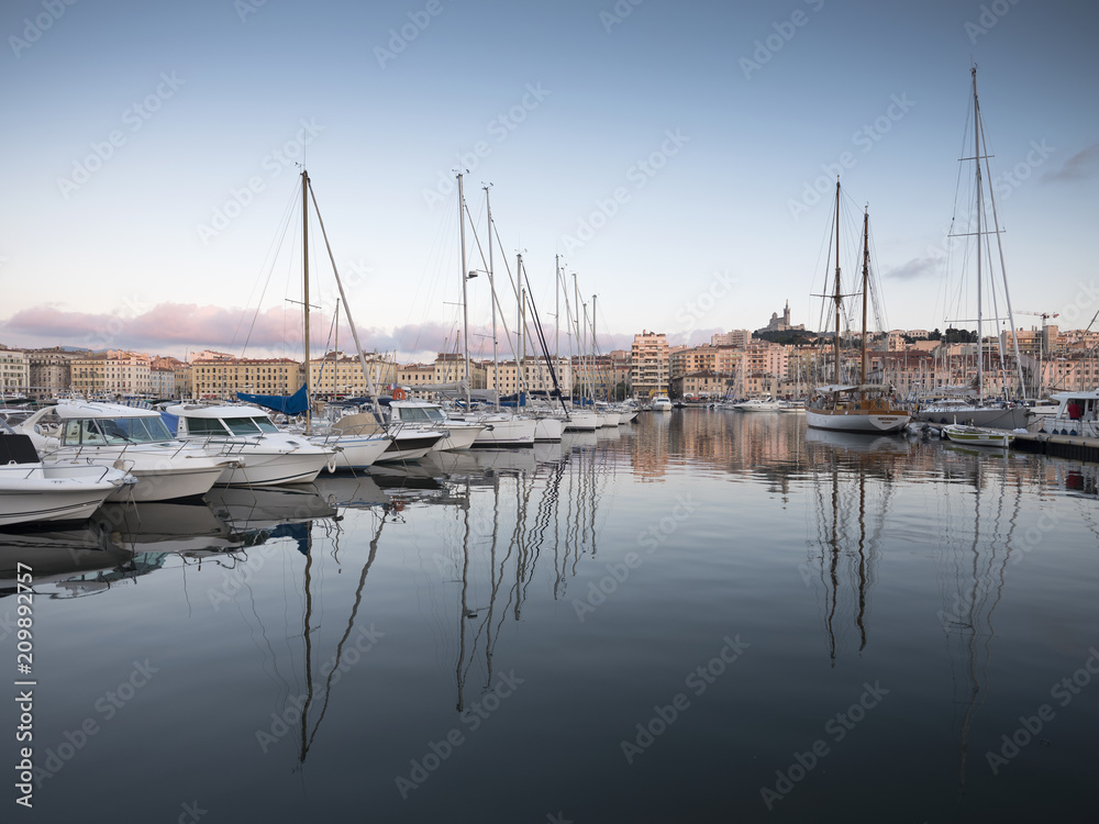 marseille, france, 4 june 2018: many fishing boats and yaughts in old harbor of french city marseille at dusk