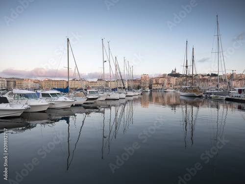 marseille, france, 4 june 2018: many fishing boats and yaughts in old harbor of french city marseille at dusk © ahavelaar