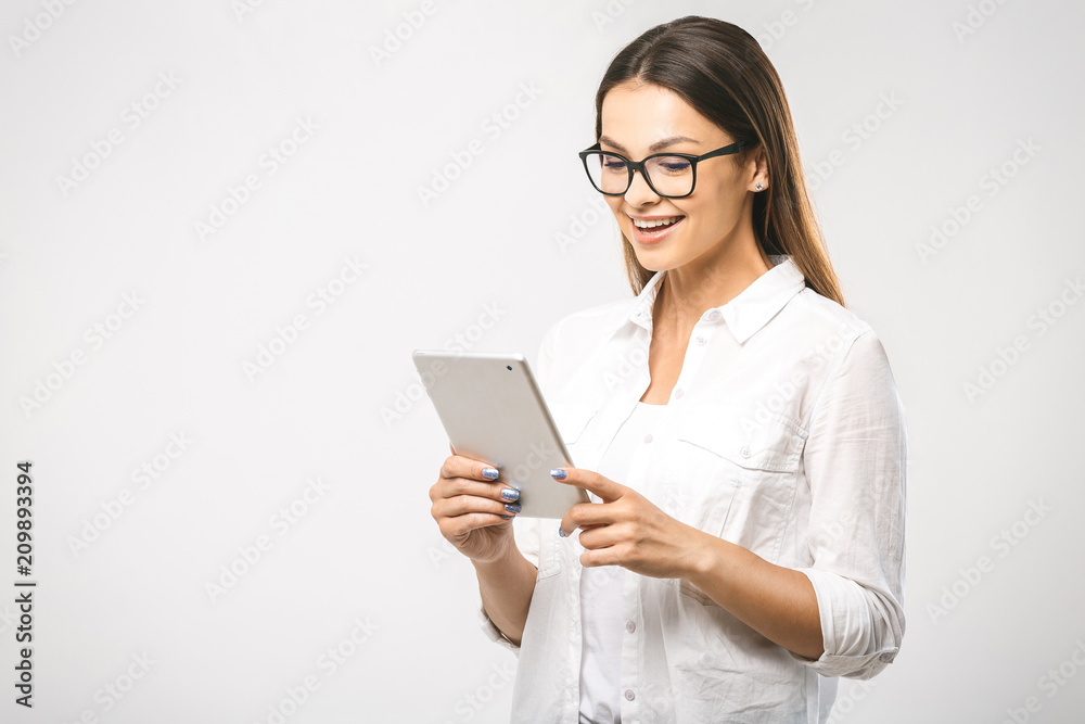 Portrait with copy space empty place of pretty charming confident trendy woman in classic shirt having tablet in hands isolated on white background Portrait with copy space empty place of pretty charming confident trendy woman in classic shirt having tablet in hands isolated on white background