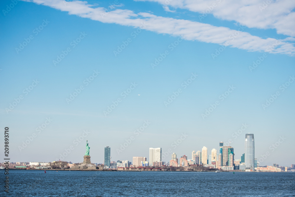 New York City Skyline over the waterfront, with Statue of Liberty