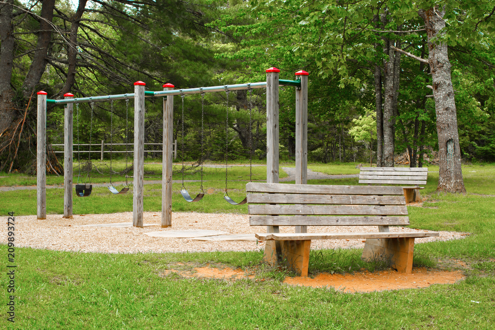 Empty children's swing set in rural park. Empty children's swing set in rural park.