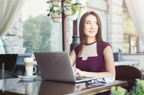 Young businesswoman outdoors working with laptop