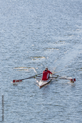 Two older men rowing a Sculling boat