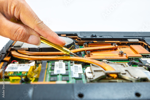 Computer repair technician is repairing the notebook or repair laptop.