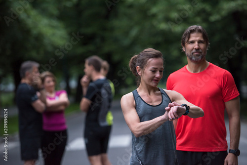 sporty couple using smart watches