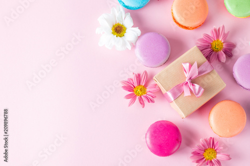 Photo of cake macarons  gift box  tea  coffee  cappuccino and flowers. Sweet romantic food macaroon concept. Morning breakfast and presents. Valentine s day concept.