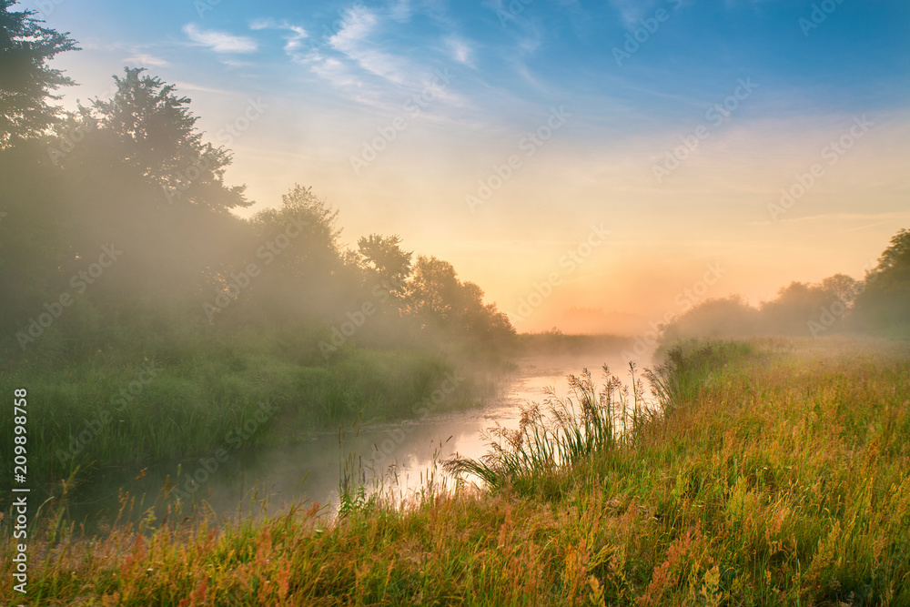 Foggy river in the morning. Summer misty sunrise on the river