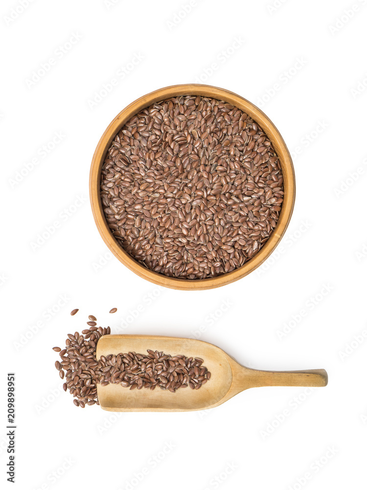 Linseed or flax seed in a wooden bowl and a spoon to the left seen from above isolated on white background Linseed or flax seed in a wooden bowl and a spoon to the left seen from above isolated on white background