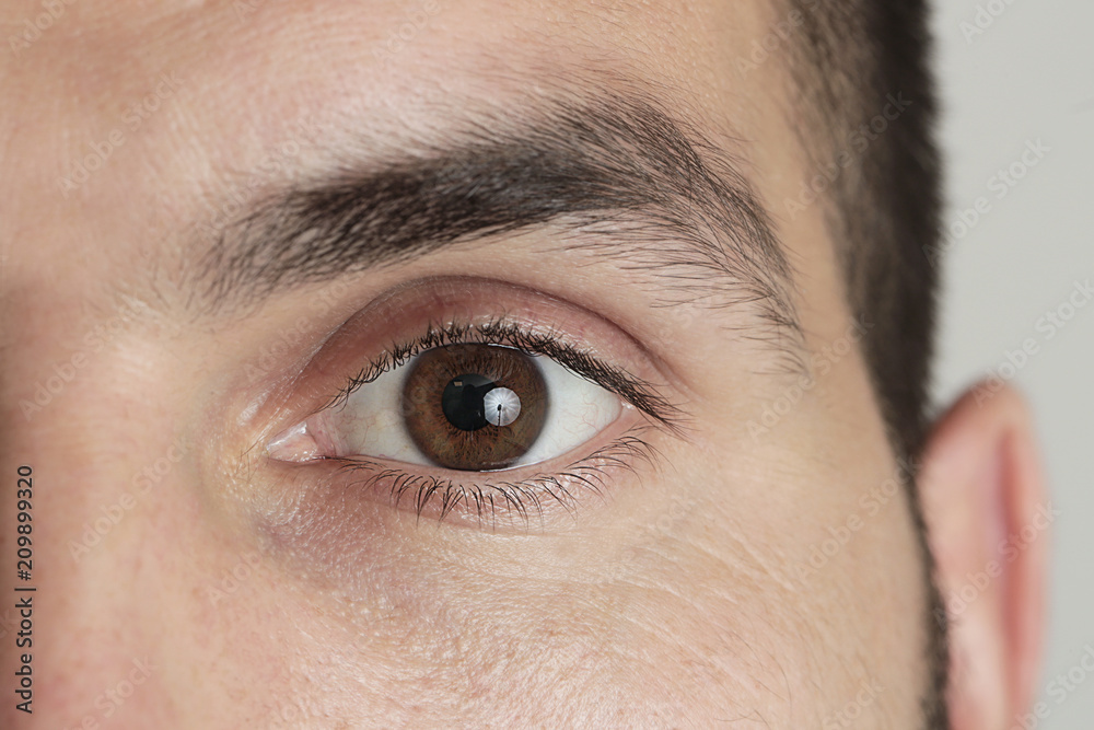 Fototapeta premium Zamknij się widok brązowego oka człowieka patrząc na kamery
