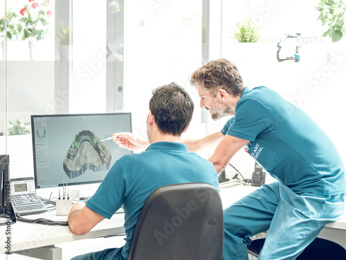 Dentists modeling jaw on computer