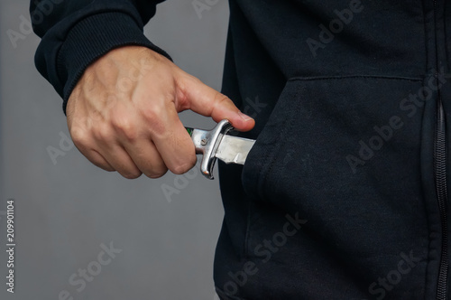 bandit pulls out his pocket folding knife to threats. photo