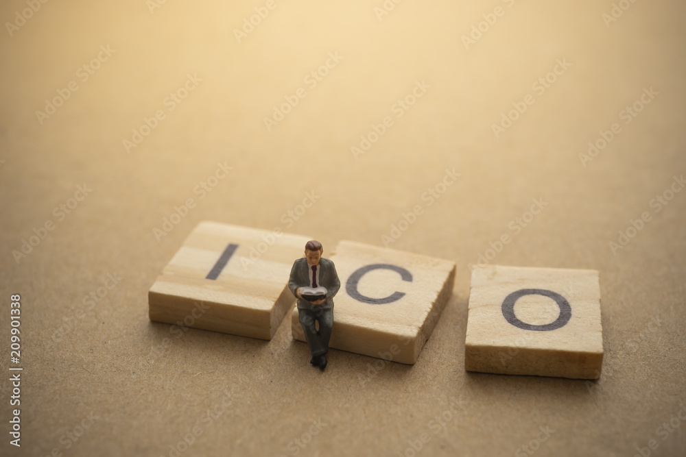 Businessman reading book about invest ICO initial coin offering concept Businessman reading book about invest ICO initial coin offering concept