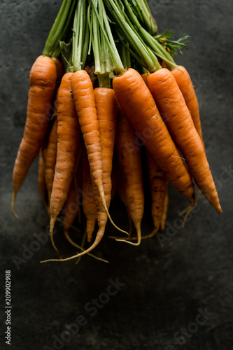 Organic Nantes Carrots on Rustic Dark Background. Fresh Superfood Healthy Eating Concept.
