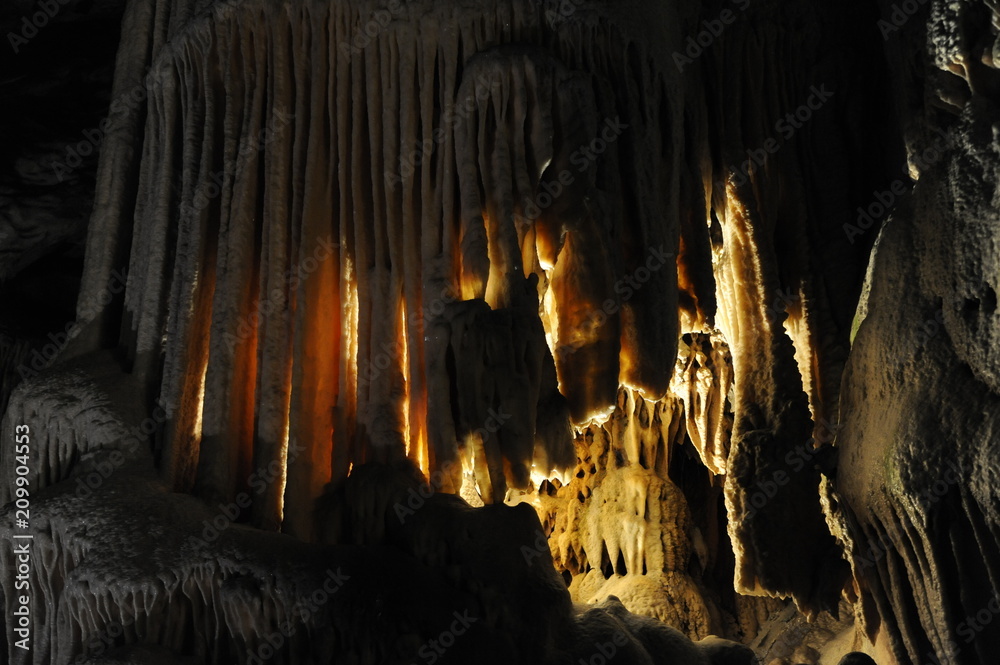 underground view of stalactites and stalagmites in natural halls in Postojna cave, Slovenia, Europe