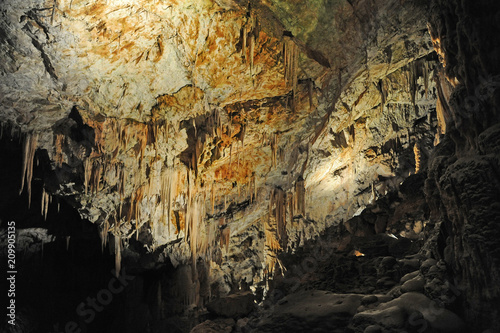 underground view of stalactites and stalagmites in natural halls in Postojna cave  Slovenia  Europe