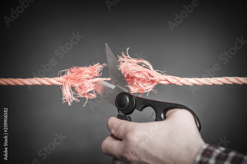 Obraz na płótnie Red rope is cut with scissors./Red rope is cut up w salonie