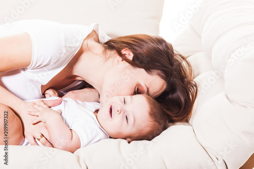 The baby gets pleasure from mom's kiss