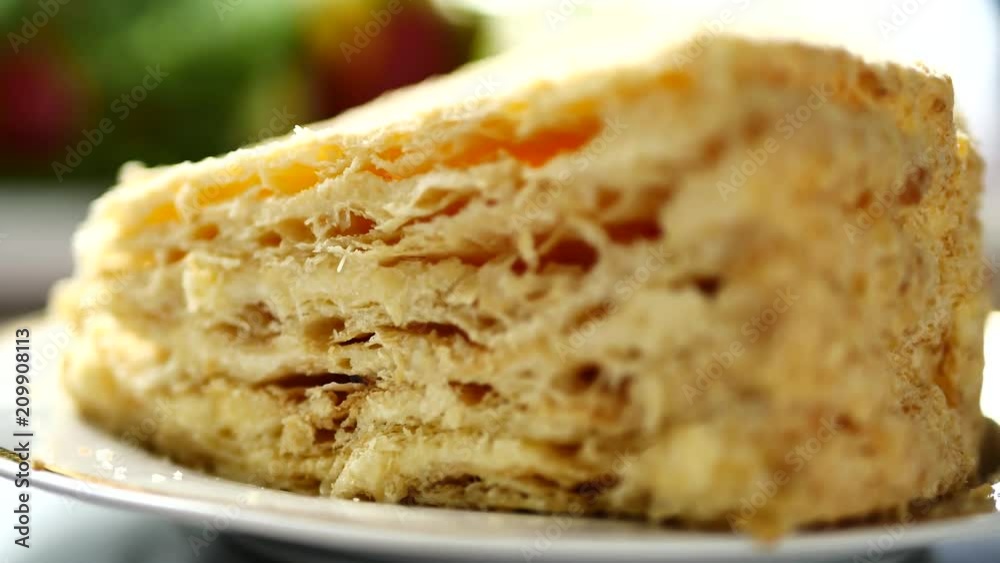 Napoleon cake with custard on platter. Dessert layered cake is chopped Napoleon cake with custard on platter. Dessert layered cake is chopped