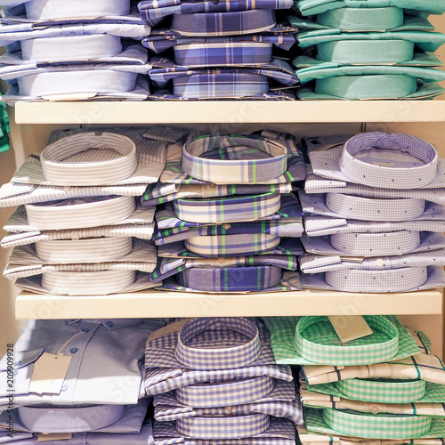 male T-shirts stacks on a shelves