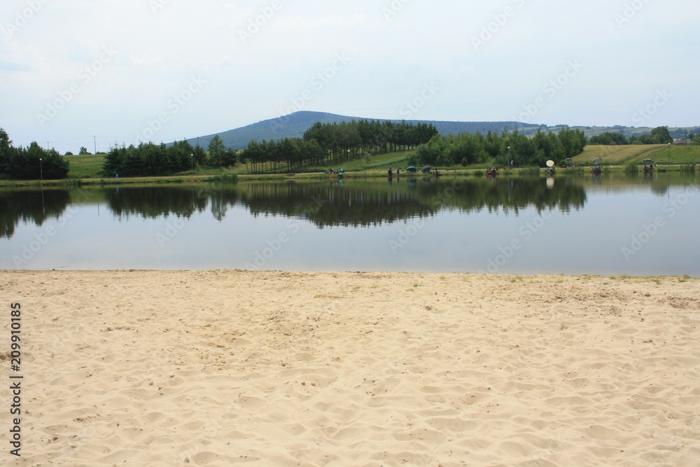 Fishing competition on a mountain lake, in the background Świętokrzyskie Mountains