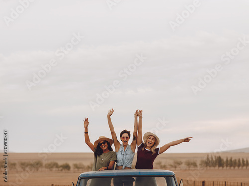 Friends having fun in the open back of a truck