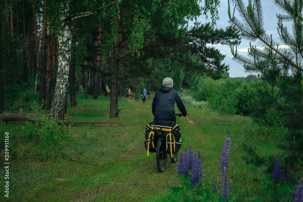 Bicyclist on the country road in village in the evening Bicyclist on the country road in village in the evening