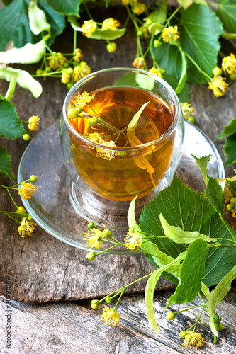 Herbal linden tea in glass cup, selective focus