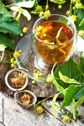 Herbal linden tea in glass cup, selective focus