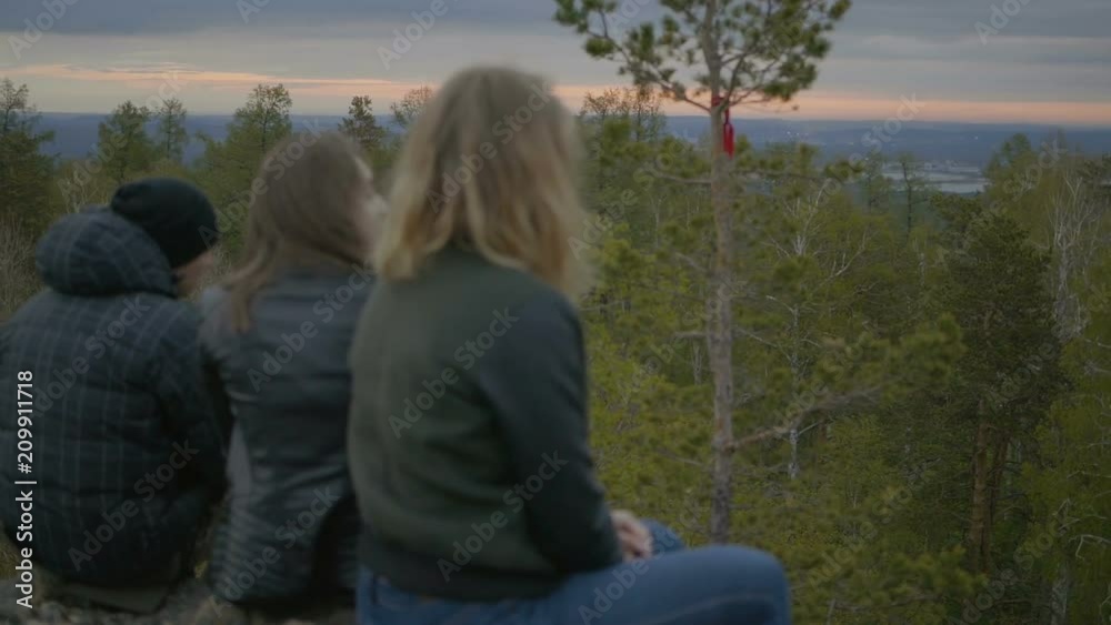 Two girls and a guy are looking into a distance Two girls and a guy are looking into a distance