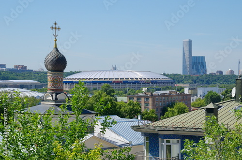 View from the observation deck of the Russian Academy of Sciences to the dome of the St. Andrew's monastery Church and the large sports arena 