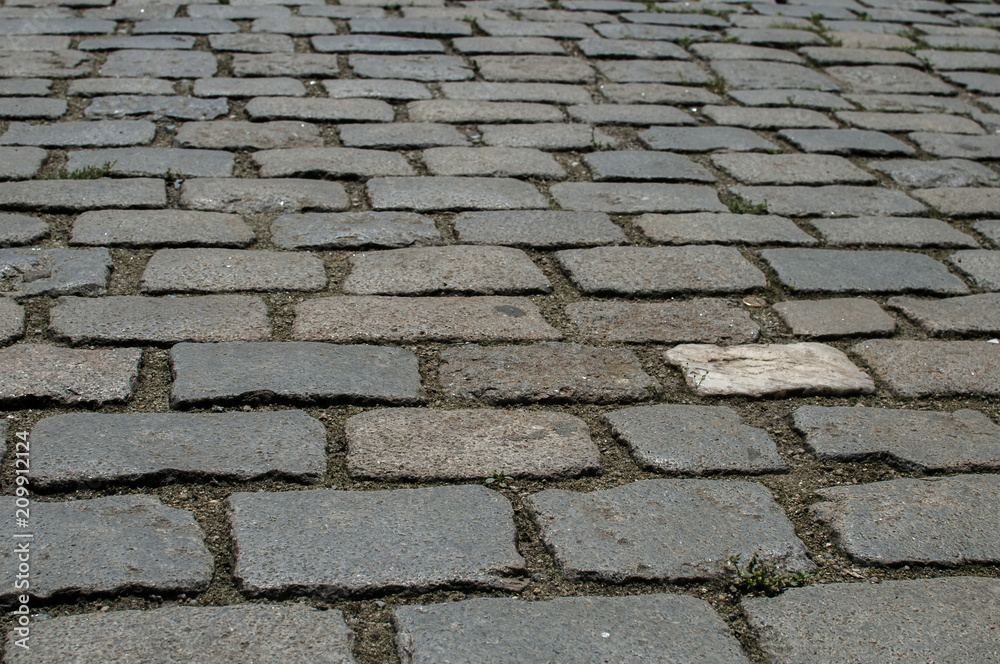 Paved old street gray surface closeup as urban background