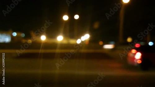 Defocused night time city driving plate shot on streets of Miami, city traffic background video