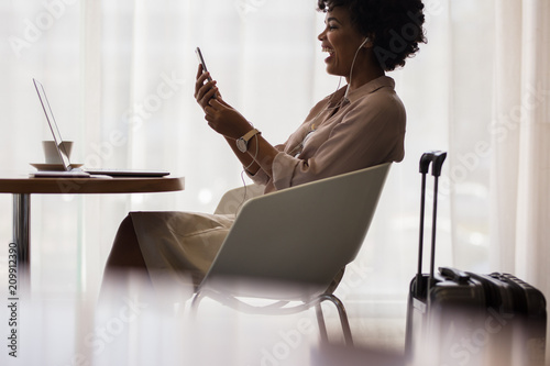 Businesswoman making video call at airport lounge photo