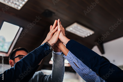 Photography Business colleagues high fiving each other.