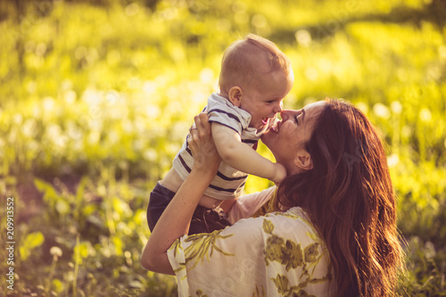 Young mother and her baby boy in nature.