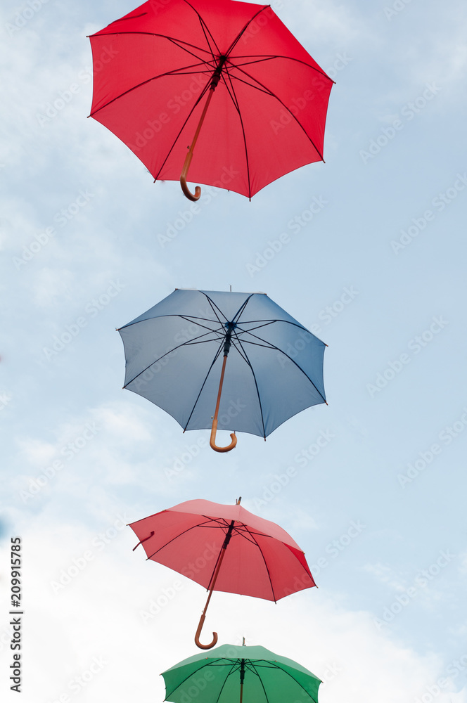 Many colorful umbrellas on the open sky