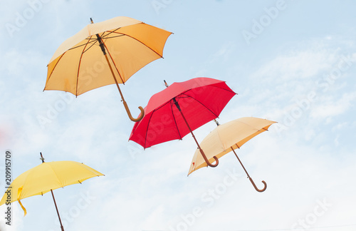 Many colorful umbrellas on the open sky